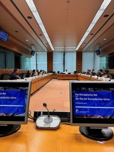 Blick von einem Platz in ein Besprechungszimmer im Europäischen Rat mit zwei Bildschirmen am Platz